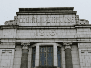 Date stone on white marble type building